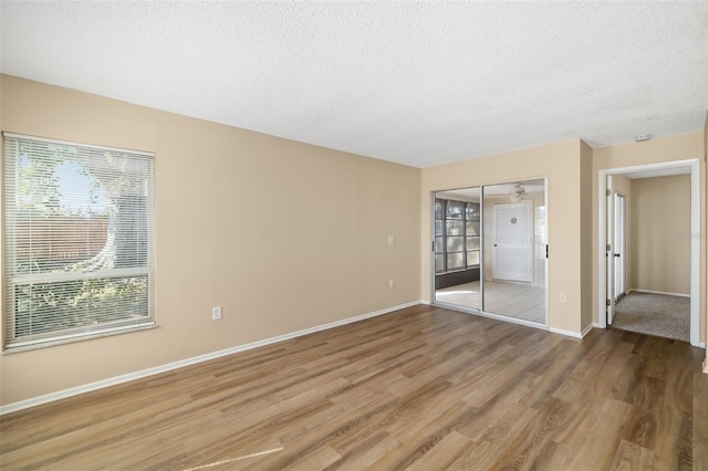 unfurnished bedroom with hardwood / wood-style floors, a closet, and a textured ceiling