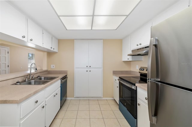 kitchen featuring sink, light tile patterned floors, stainless steel appliances, and white cabinets