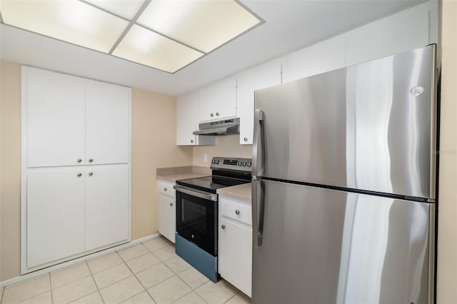 kitchen with stainless steel appliances, white cabinetry, and light tile patterned floors