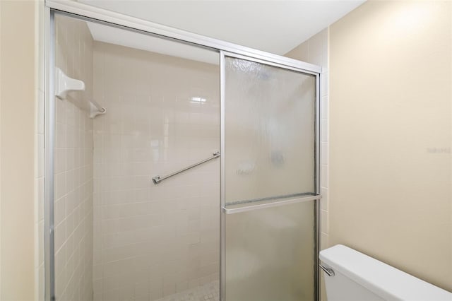 bathroom with walk in shower and toilet