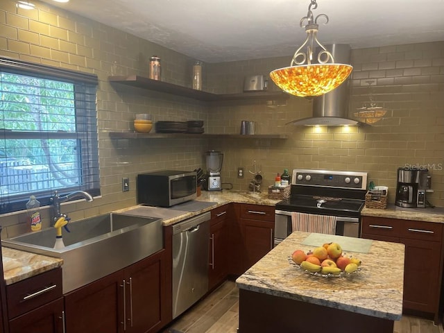 kitchen with sink, decorative backsplash, stainless steel appliances, and light stone countertops