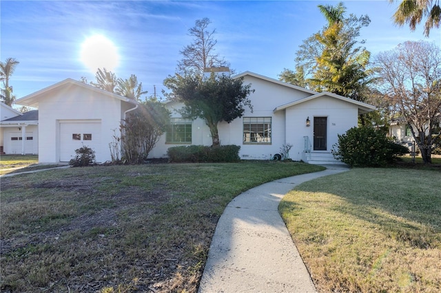 single story home featuring a garage and a front lawn