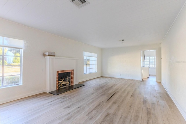 unfurnished living room with a fireplace and light hardwood / wood-style flooring