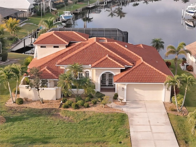 view of front of property featuring french doors, a water view, a garage, a front yard, and glass enclosure