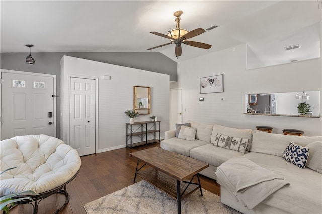 living room featuring dark wood-type flooring, ceiling fan, and vaulted ceiling