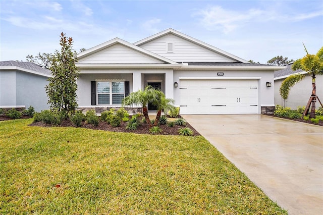 view of front of home with a garage and a front lawn