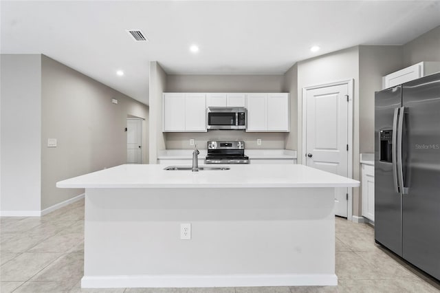 kitchen with sink, light tile patterned floors, a kitchen island with sink, stainless steel appliances, and white cabinets