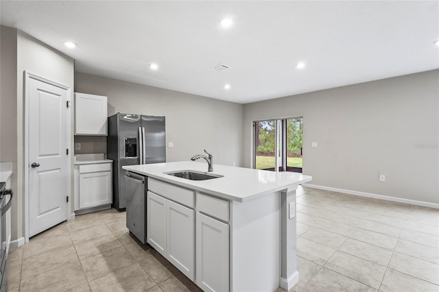 kitchen featuring white cabinetry, sink, a kitchen island with sink, light tile patterned floors, and stainless steel appliances