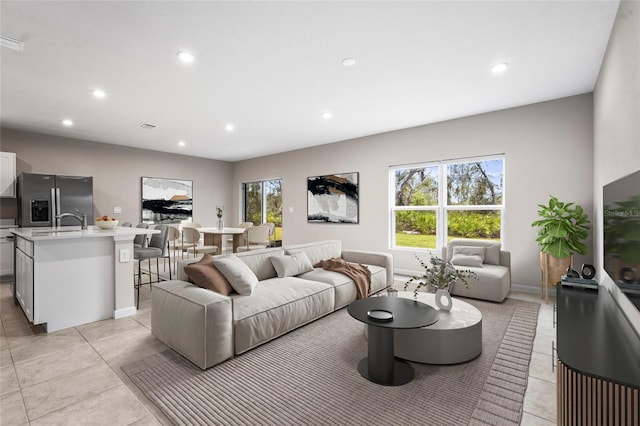 living room with light tile patterned flooring and sink