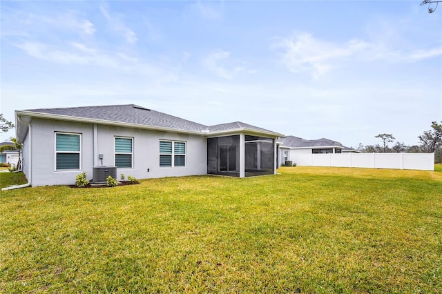 back of property featuring a sunroom and a yard