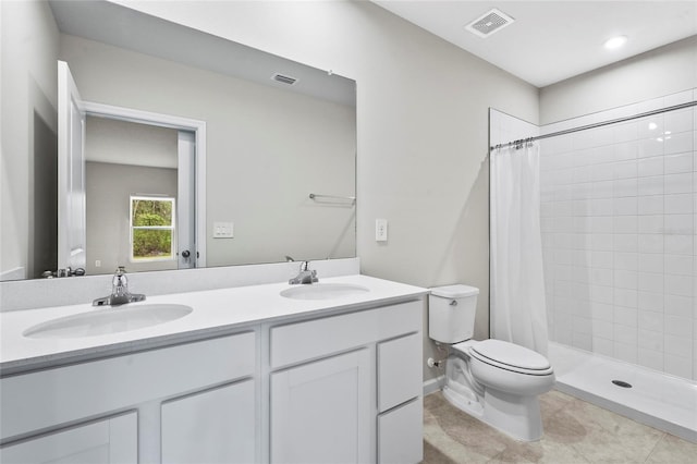 bathroom featuring vanity, curtained shower, and toilet