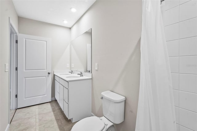 bathroom with tile patterned flooring, vanity, and toilet