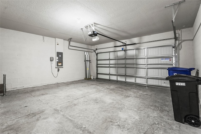 garage with a garage door opener and electric panel