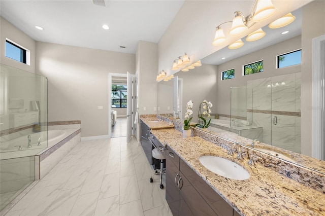 bathroom featuring shower with separate bathtub and vanity