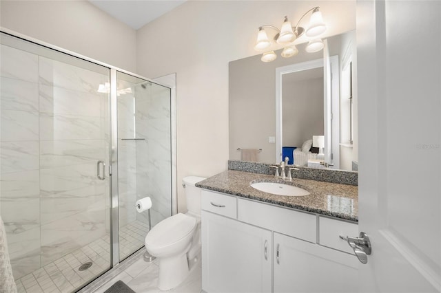 bathroom featuring vanity, toilet, and a shower with shower door