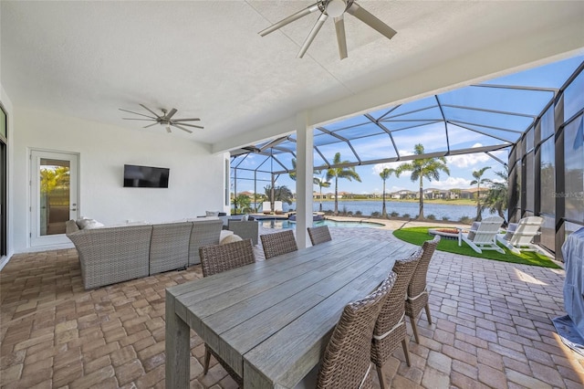 view of patio / terrace featuring ceiling fan, a swimming pool with hot tub, an outdoor living space, and a lanai