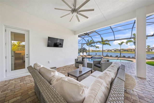 view of patio / terrace featuring a swimming pool with hot tub, a lanai, and an outdoor hangout area