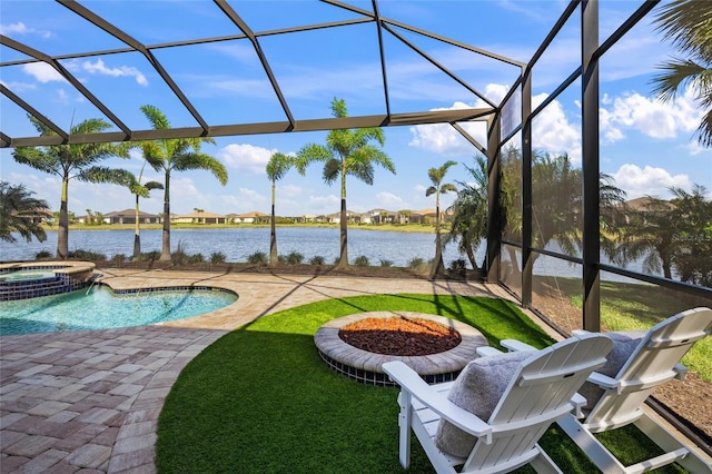 view of pool featuring an in ground hot tub, glass enclosure, and a water view