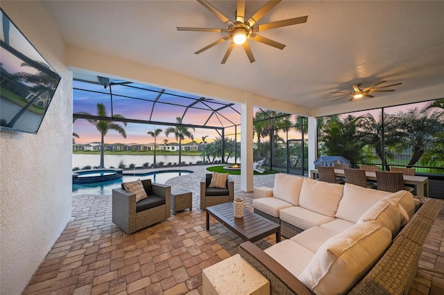 patio terrace at dusk with a pool with hot tub, an outdoor living space, and glass enclosure