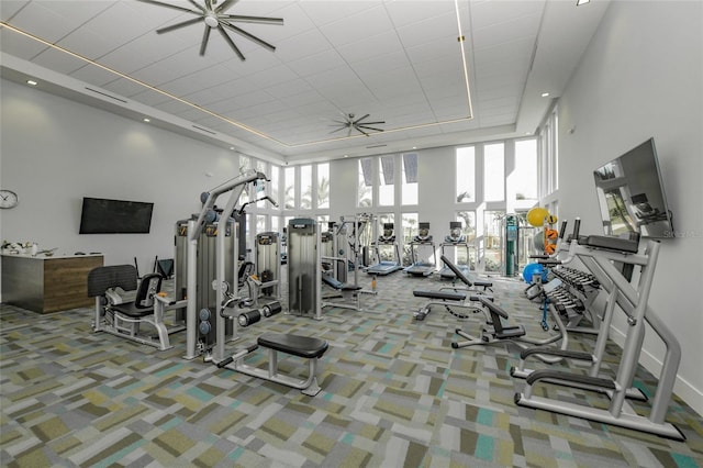 gym with carpet floors and a high ceiling