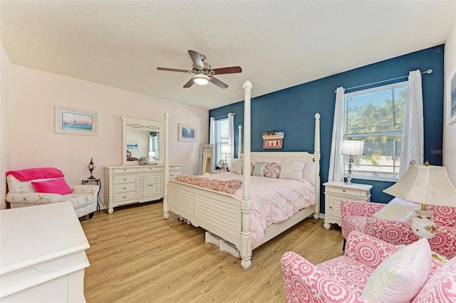 bedroom with light wood-type flooring and ceiling fan