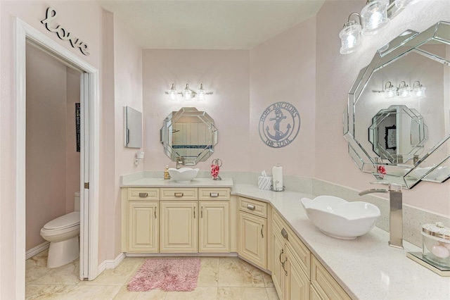 bathroom with vanity, tile patterned floors, and toilet