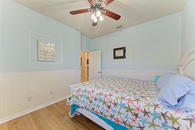 bedroom with ceiling fan and wood-type flooring