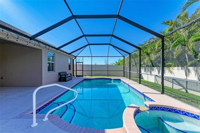 view of swimming pool featuring glass enclosure, a patio, a fenced backyard, and a pool with connected hot tub