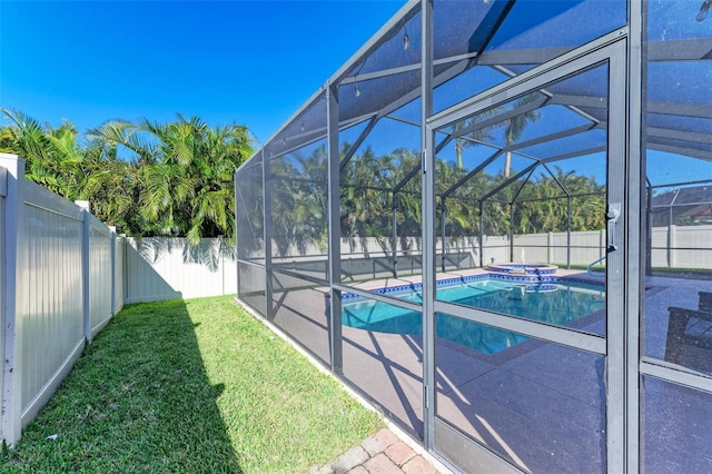 view of swimming pool with a fenced in pool, a lanai, a lawn, a fenced backyard, and a patio