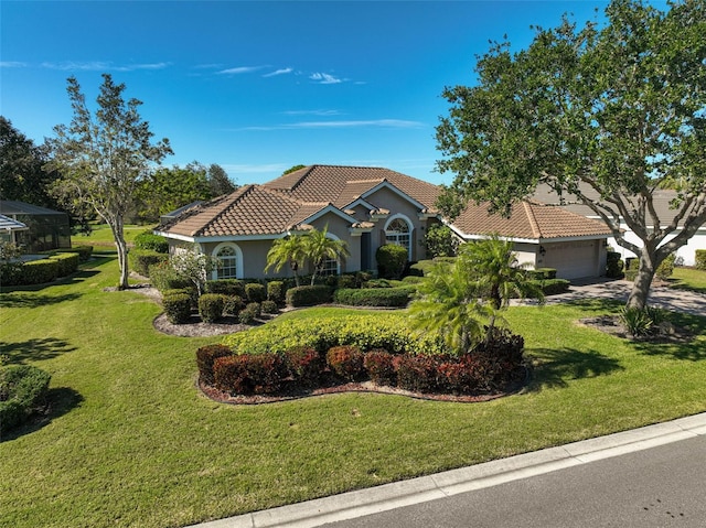 mediterranean / spanish-style house with a garage and a front yard