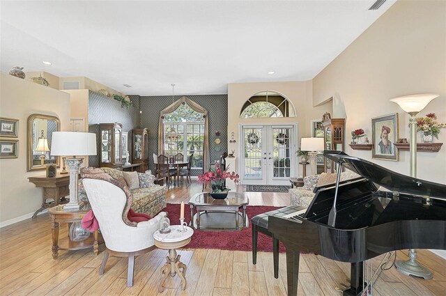 living room with french doors and light hardwood / wood-style flooring