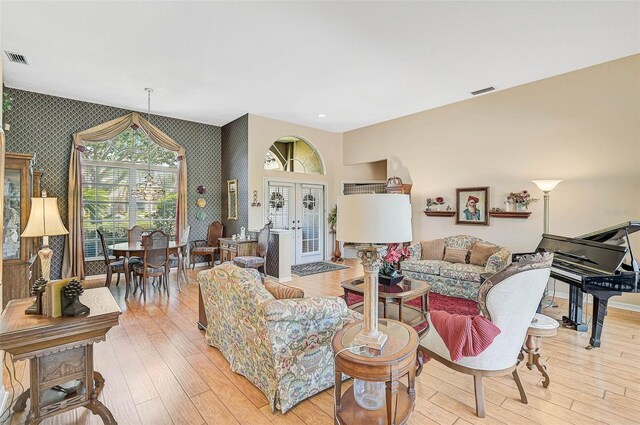 living room with french doors and light hardwood / wood-style floors