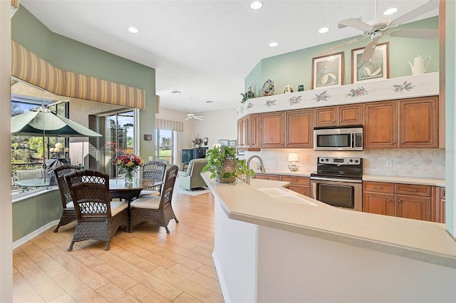 kitchen with tasteful backsplash, ceiling fan, stainless steel appliances, and sink