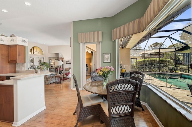 dining area with sink and light hardwood / wood-style flooring