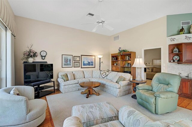 living room featuring ceiling fan and light wood-type flooring