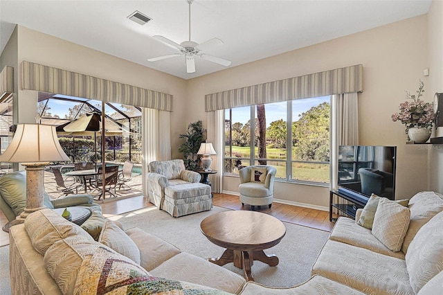 living room with ceiling fan and light hardwood / wood-style floors