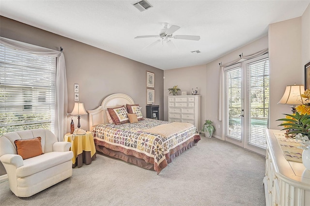 carpeted bedroom with access to exterior and ceiling fan