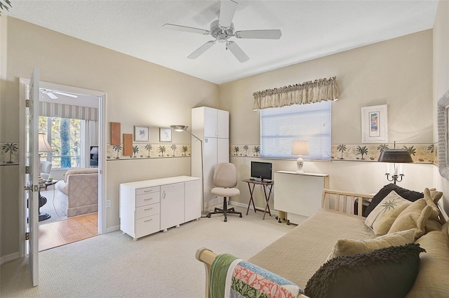 living area featuring light colored carpet and ceiling fan