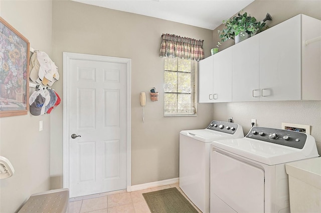 washroom featuring cabinets, sink, light tile patterned floors, and washer and clothes dryer