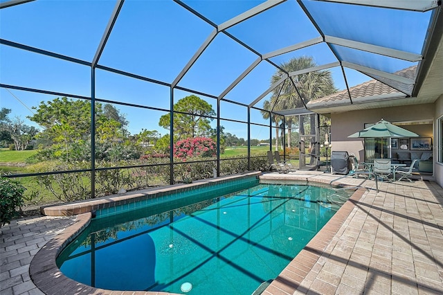 view of pool with a lanai and a patio