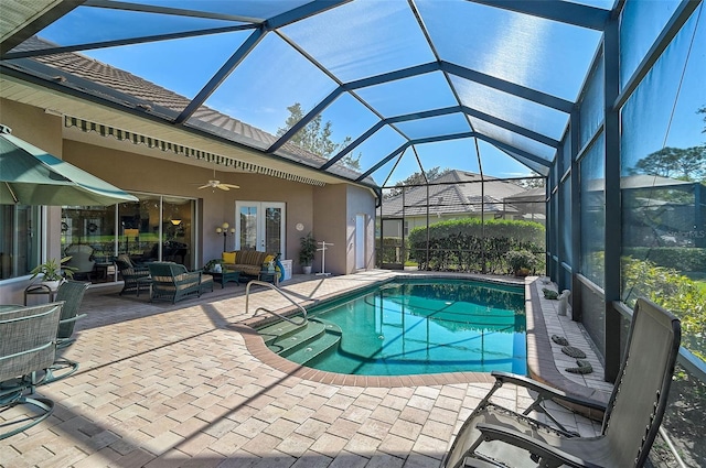 view of swimming pool featuring an outdoor living space, a patio, a lanai, and ceiling fan