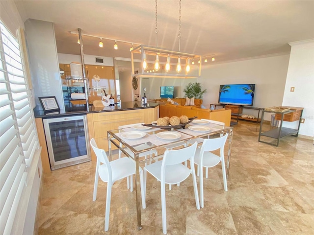 dining space featuring ornamental molding and beverage cooler