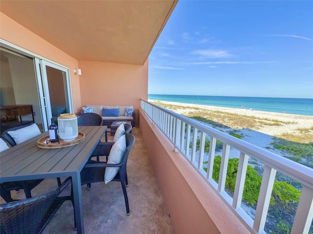 balcony featuring a water view and a view of the beach