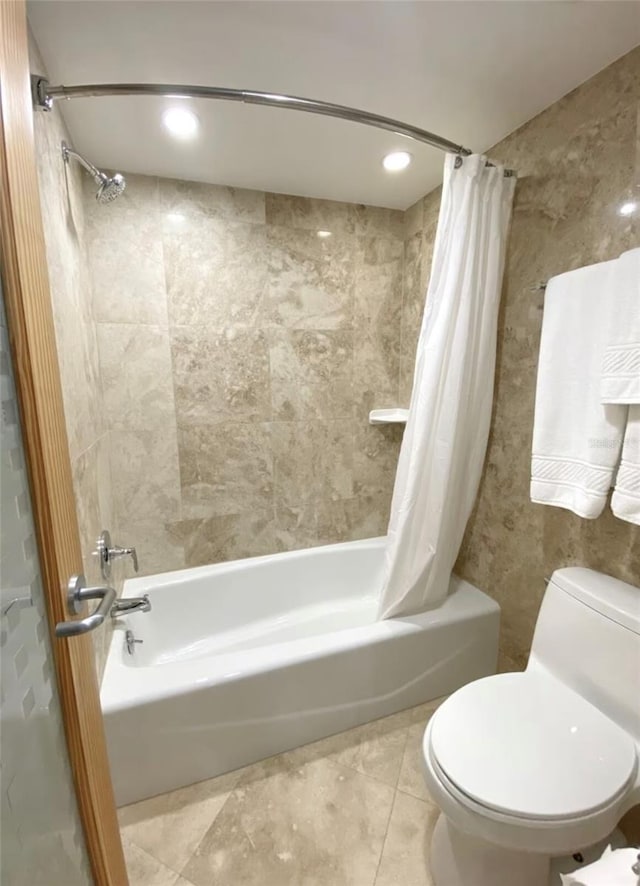 bathroom with shower / bath combo, tile patterned floors, and toilet