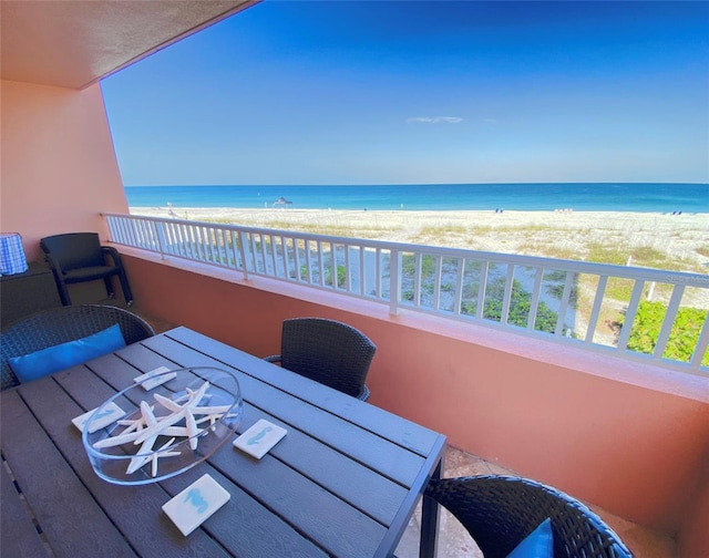 balcony featuring a water view and a view of the beach