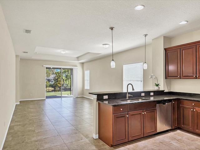kitchen featuring sink, a tray ceiling, stainless steel dishwasher, and kitchen peninsula