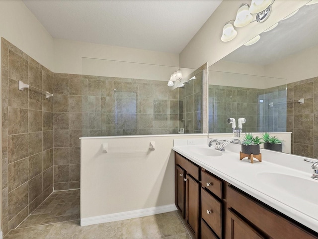bathroom featuring vanity and tiled shower
