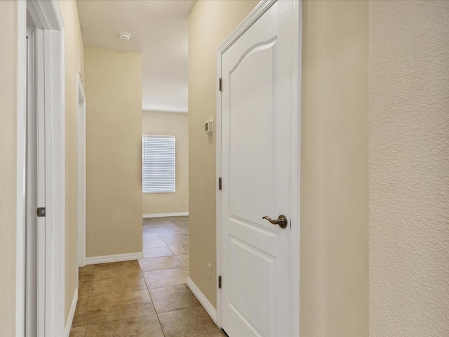 hall with light tile patterned floors