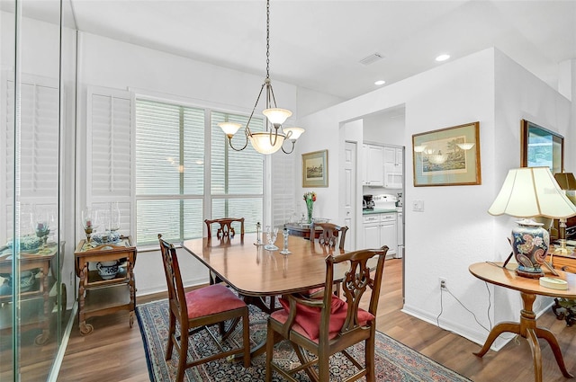 dining room featuring an inviting chandelier and hardwood / wood-style floors