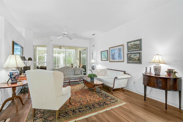 living room featuring ceiling fan and light wood-type flooring